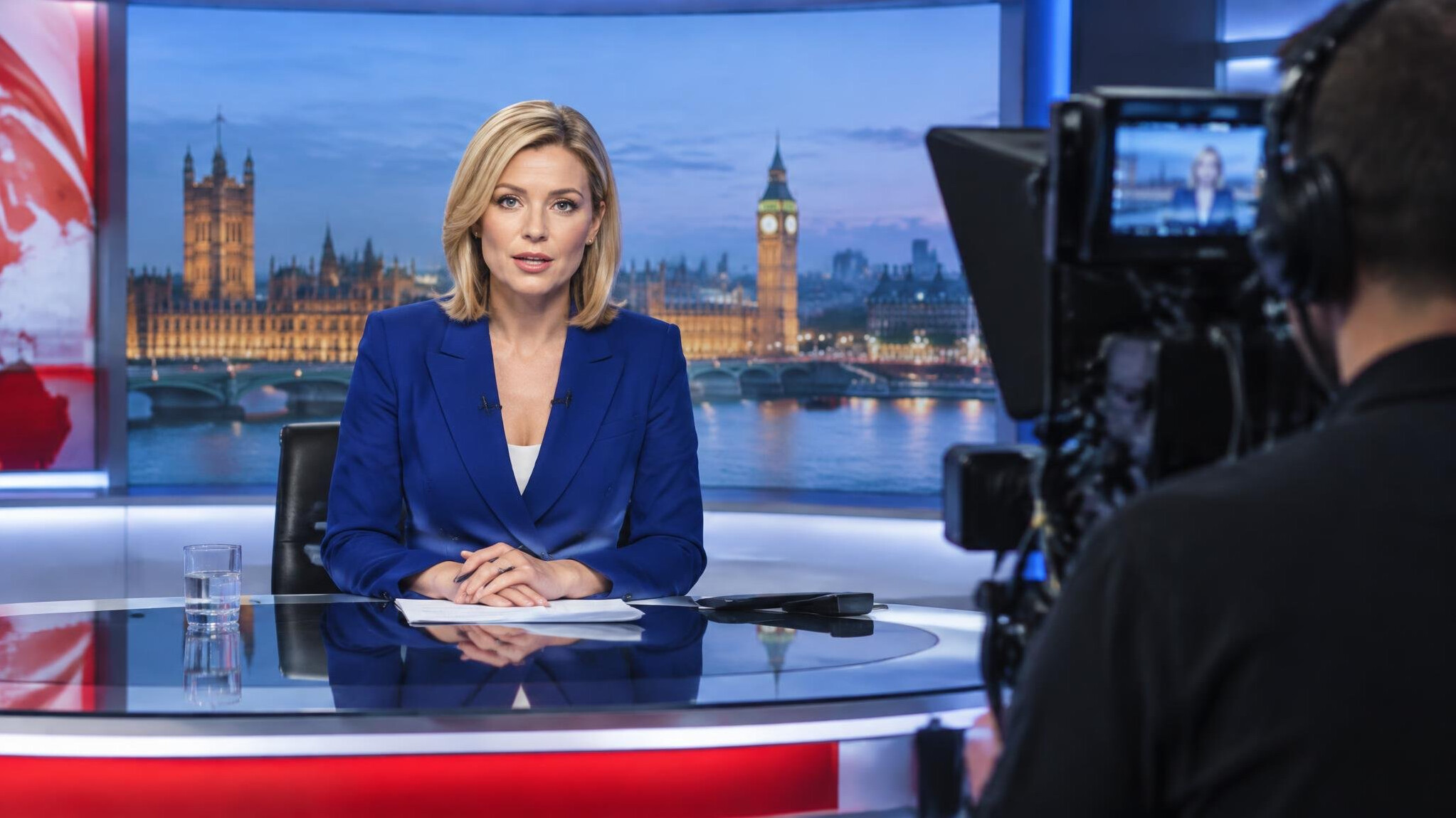 News anchor presenting live in a television studio under broadcast lighting