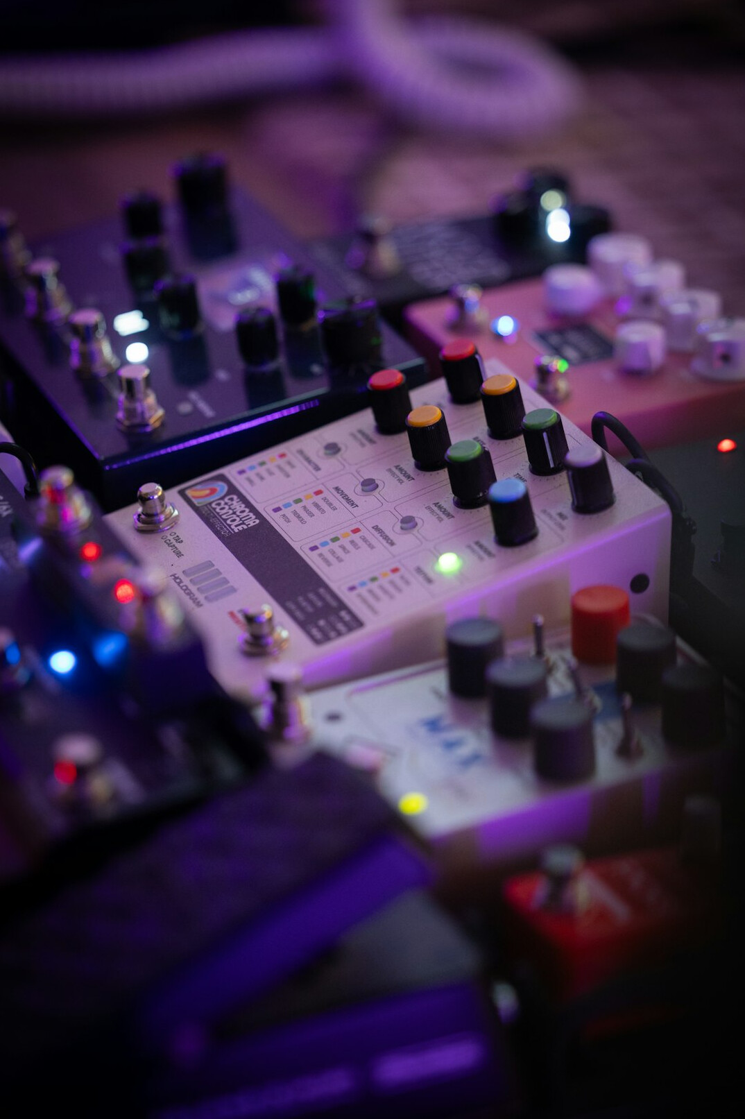 Audio mixing desk with sliders and meters in a broadcast sound booth